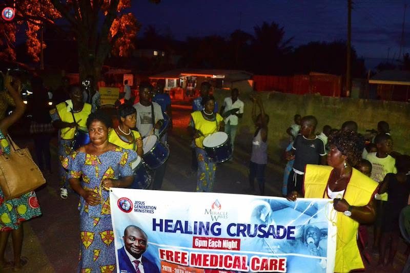 A procession through the town behind the Healing Crusade and Free Medical Care banner