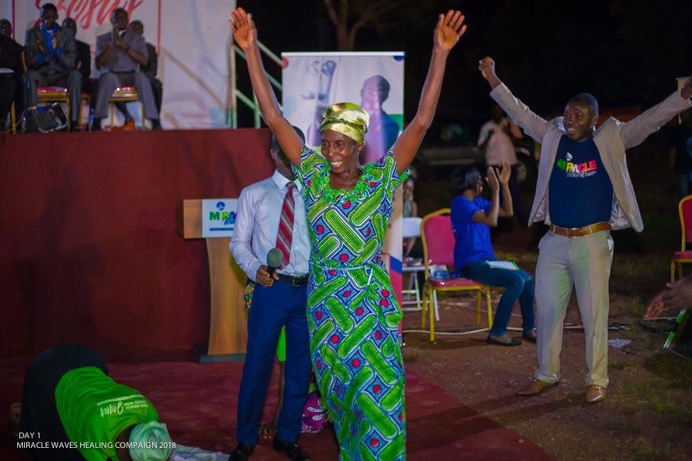 The same woman with both arms raised