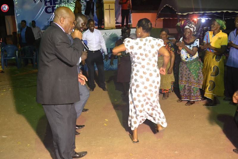 A woman moving toward the minister during an evening service