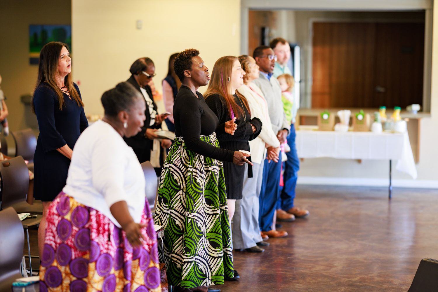 The congregation standing in worship at the inauguration